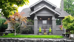 A modern house with a stone facade, a front porch, and a well-maintained garden. - Updated Tacoma Home w/ Patio: 3 Mi to Downtown (Tacoma)