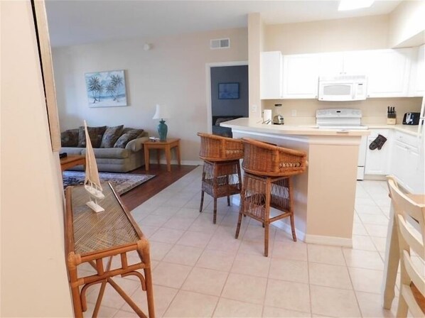 A compact living space with a kitchen, dining area, and a living room.