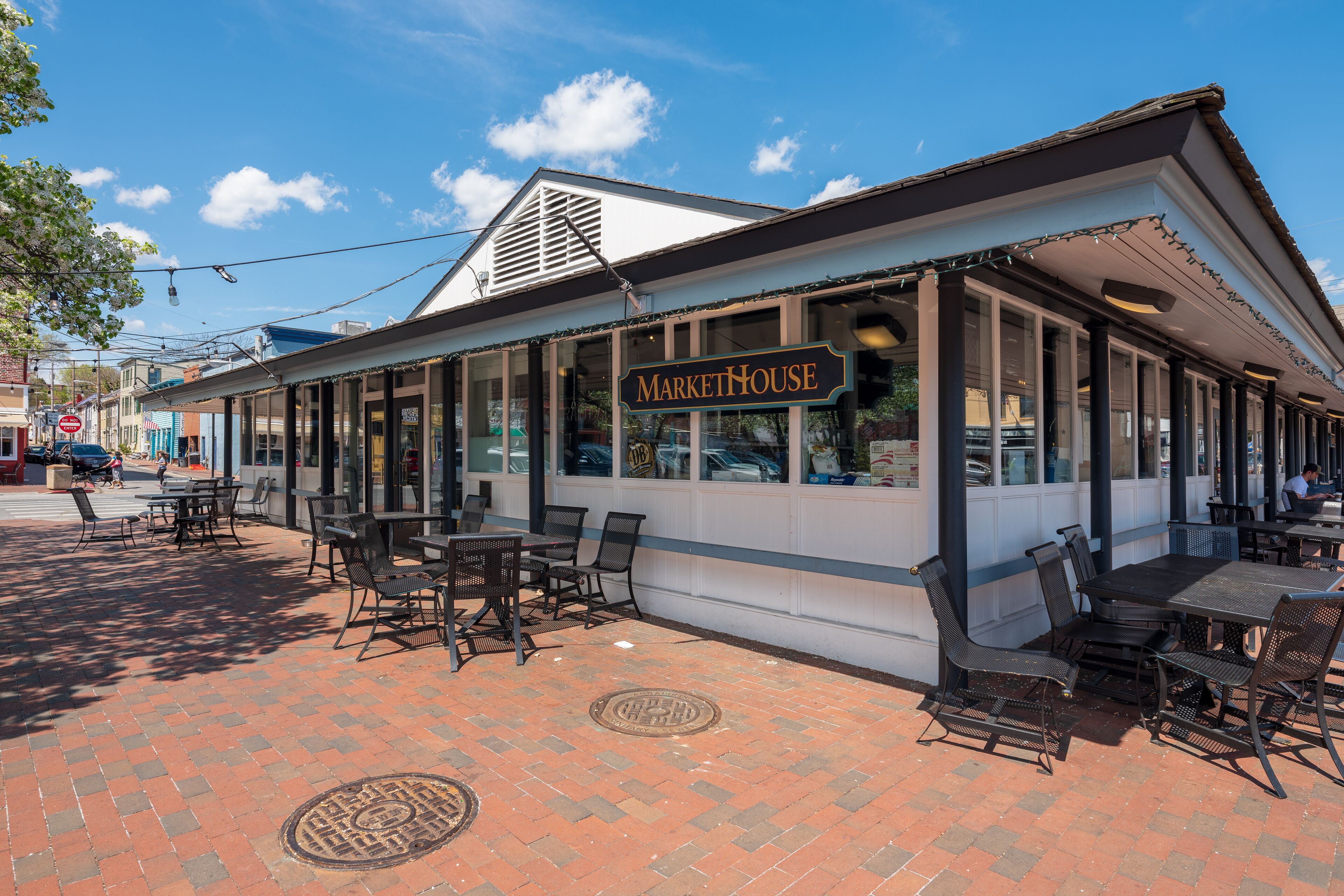 A MarketHouse with outdoor seating and a brick-paved patio.