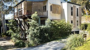 A modern two-story house with a balcony and a staircase leading to an upper level. - Spacious home with views suitable for 2 families (Point Lookout)