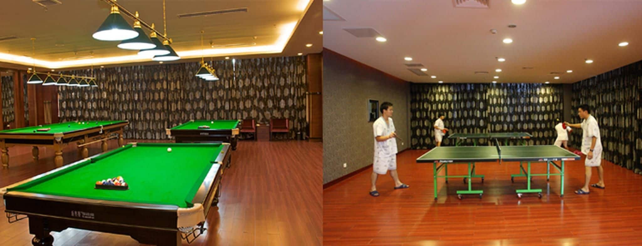 A billiards room with multiple tables and a pool table.