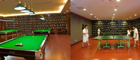 A billiards room with multiple tables and a pool table.