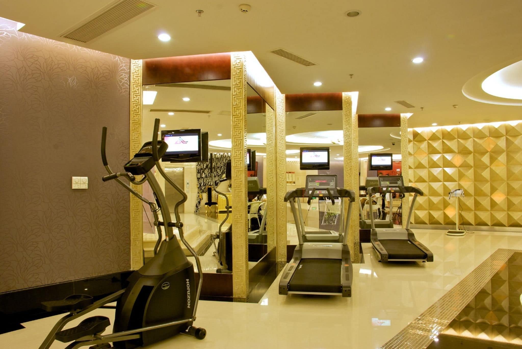 A gym with treadmills, an elliptical, and exercise equipment.