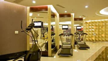 A gym with treadmills, an elliptical, and exercise equipment.