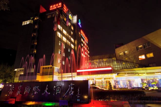 A multi-story hotel with a prominent water feature in front.