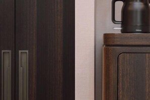A dark wooden cabinet with a black coffee maker on top. - Huangyan International Hotel (Taizhou)