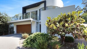 A modern two-story house with a garage, large windows, and a well-maintained garden. - The White House - Merimbula (Merimbula)