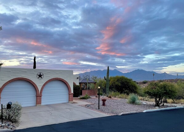 A building with two garage doors, a star emblem, and a cactus in the foreground. - AZ Desert Hills II Townhouse, Private with Stunning Mountain View! (Green Valley)
