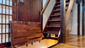 A wooden staircase with a wooden door and a window with a grid pattern. - 5 Min from Seoul Station! Authentic meets Modern & Cozy Retreat (Seoul)