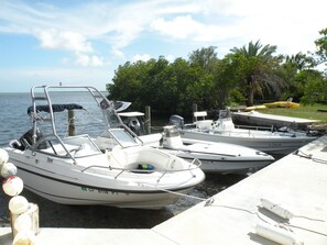 Boats dock at a tranquil marina surrounded by lush greenery and calm waters.