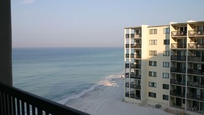 A beachfront hotel with multiple balconies, a sandy beach, and a view of the ocean. - Three Bedroom Beachfront Condo at Pinnacle Port  (Panama City Beach)