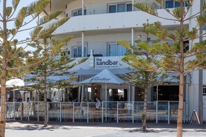 A beachfront bar named 'The Sandbar' with outdoor seating and a white facade. - West Beach Lagoon 202 - Quiet & Ground Floor! (Scarborough)