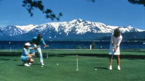 A golf course with a mountainous backdrop. - SKI MOUNTAIN GETAWAY! AMAZING LOCATION FOR SKIING, HIKING AND SEEING LAKE TAHOE. (Stateline)