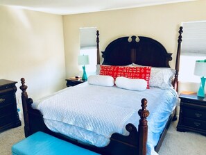 A four-poster bed with a quilted bedspread, two bedside tables with lamps, and a bench at the foot of the bed. - MODERN NEWER HOME CLOSE TO NAPA WINE COUNTRY, SACRAMENTO &  SAN FRANCISCO (FAIRFIELD)