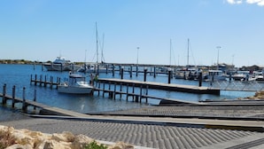A marina with boats docked at wooden piers.