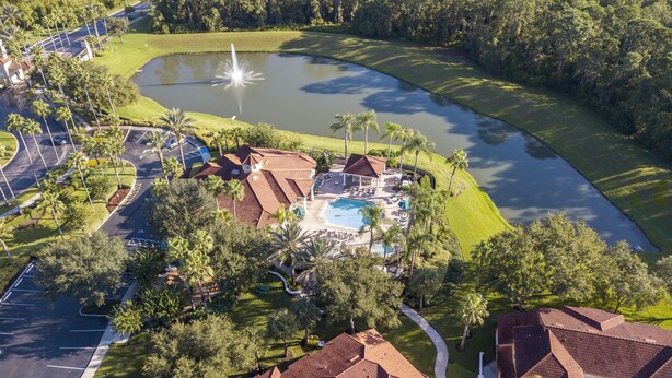 An aerial view of a resort with a swimming pool, a fountain, and a parking area. - Your perfect stay starts here. Near Disney/Universal. (Kissimmee)