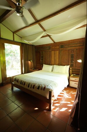 A room with a large bed, wooden headboard, and a ceiling fan. - Exotic Luxury Villa with private Pool at Gili Trawangan (Gili Indah)