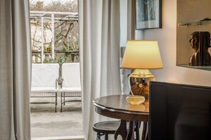 Cozy retreat with a round table, comfortable chair, and large window.