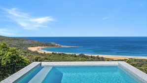 A swimming pool with a view of a beach and ocean. - 33 Degrees - Stunning Views by HolidayCo. (KILLCARE HEIGHTS)