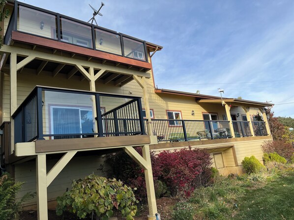 A two-story house with a balcony and a satellite dish.