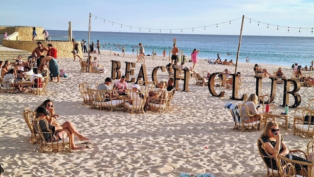 A beach club with wicker chairs and tables, a stone wall, and the ocean in the background. - West Beach Lagoon 123 - Location &amp; Views!!! (Scarborough)
