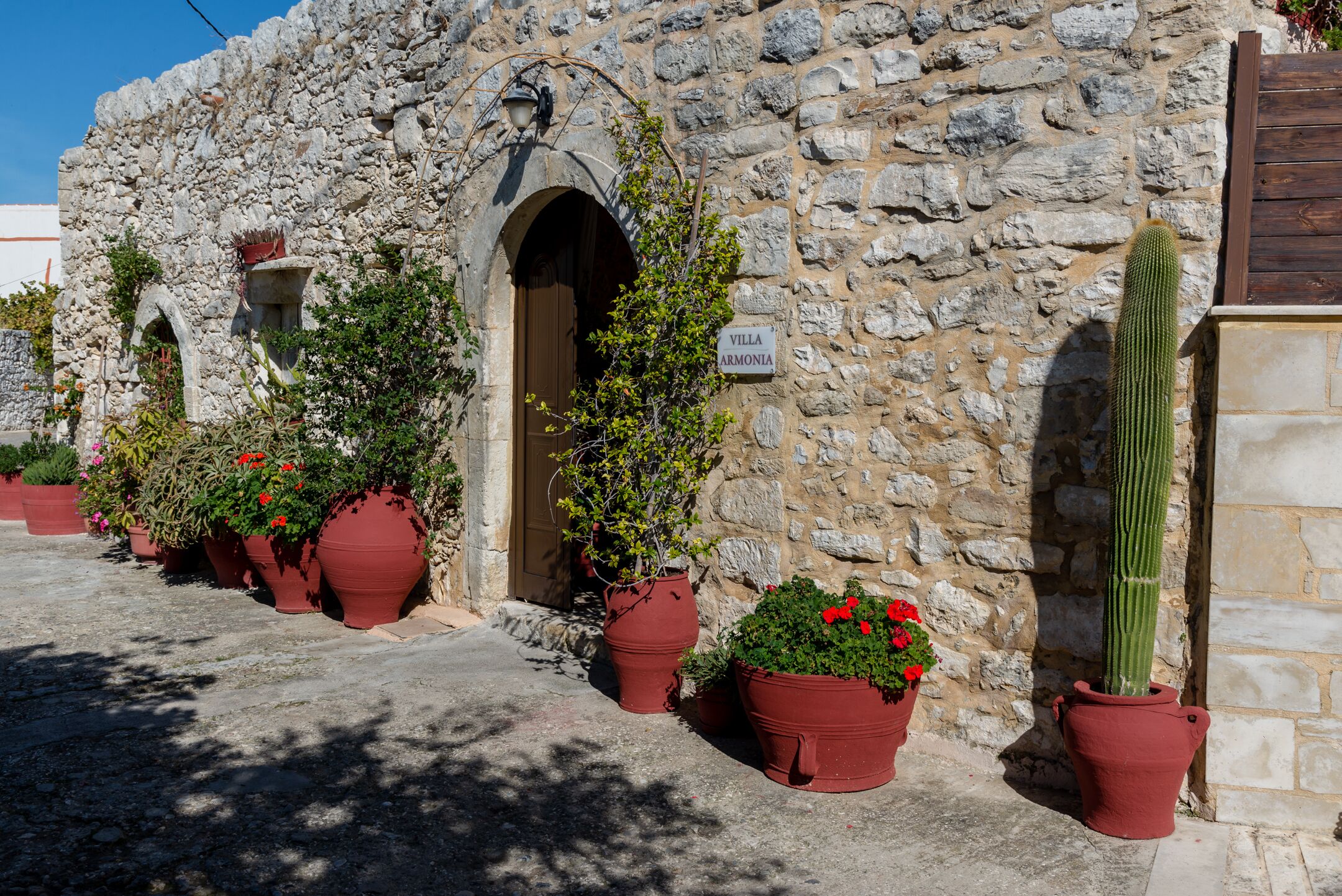 A stone building with a sign reading "Villa Armonia."