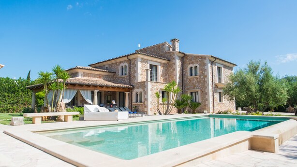 A large stone house with a swimming pool, outdoor seating, and a well-maintained garden. - PREMIUM: GRAND AND ELEGANT VILLA (Sa pobla)
