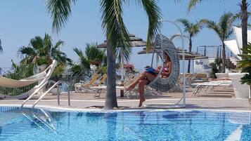 Seasonal outdoor pool, pool loungers