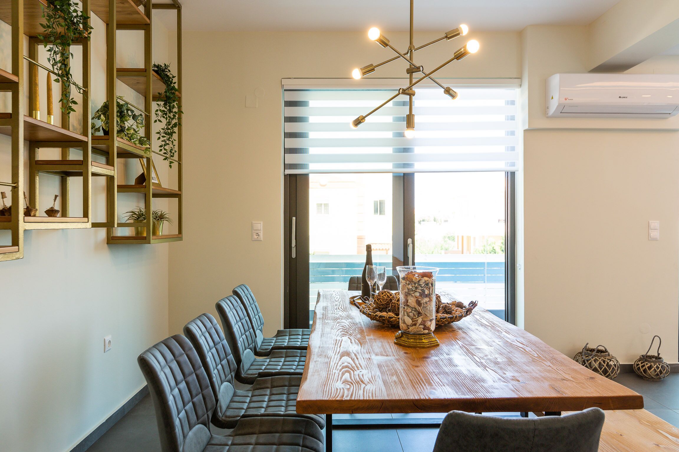 A dining area with a wooden table, cushioned benches, and a decorative centerpiece.