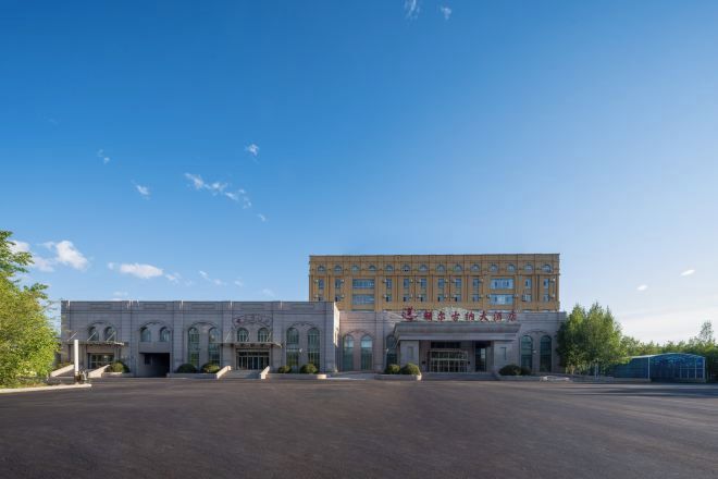 A building with a large entrance and a smaller attached structure.
