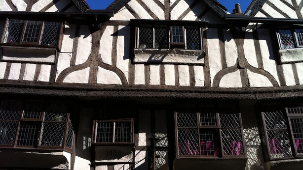 Un edificio tradizionale con struttura a graticcio, diverse finestre e il numero '1434' ben visibile.