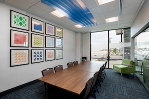 A conference room with a long table, chairs, and framed artwork on the wall. - Holiday Inn Express Lethbridge Southeast by IHG (Lethbridge)