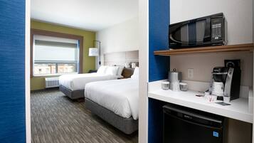 A hotel room with two beds, a microwave, a coffee maker, and a dishwasher.