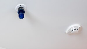 Two smoke detectors mounted on a white ceiling. - Holiday Inn Express Lethbridge Southeast by IHG (Lethbridge)
