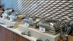 A buffet setup with labeled containers for different types of food, including turkey sausage and pork sausage. - Holiday Inn Express Lethbridge Southeast by IHG (Lethbridge)