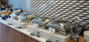 A buffet setup with labeled containers for different types of food, including turkey sausage and pork sausage. - Holiday Inn Express Lethbridge Southeast by IHG (Lethbridge)