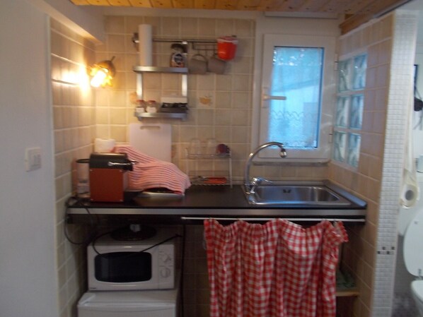 Fridge, microwave, coffee/tea maker, cookware/dishes/utensils