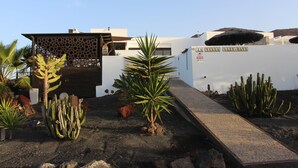 A desert landscape with cacti and a building with a sign reading "LAZY DAYS". - Luxury Villa with Private Heated pool, FREE WiFi,  (Playa Blanca, Yaiza)