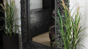 A large, ornate mirror with a textured frame, flanked by two potted plants. - Luxury Villa with Private Heated pool, FREE WiFi,  (Playa Blanca, Yaiza)