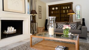 A living room with a fireplace, a glass coffee table, a sofa, and a bookshelf. -  BEAUTIFUL FARMHOUSE IN PROVENCE.. (Rognes)