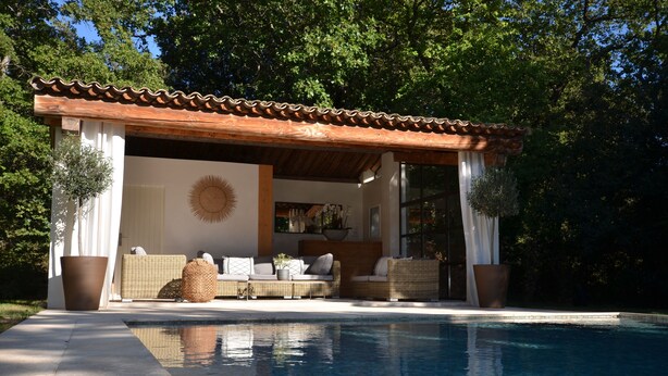 A covered outdoor seating area with wicker furniture and a pool. -  BEAUTIFUL FARMHOUSE IN PROVENCE.. (Rognes)