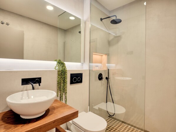 A modern bathroom with a glass-enclosed shower, a white sink, and a toilet. - Two Bedroom apartment in Pere IV - You Stylish (Barcelona)