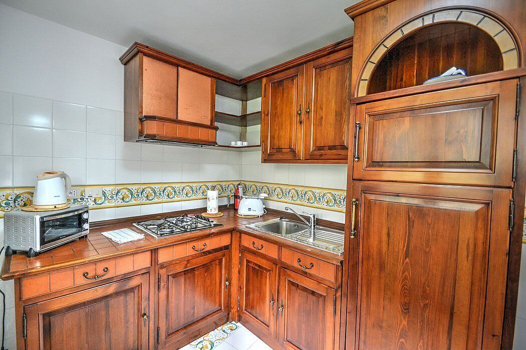 Appartamento Ulisse I: A characteristic two-story cottage located in an isolated position, on the slopes of a hill which is covered with olive groves.