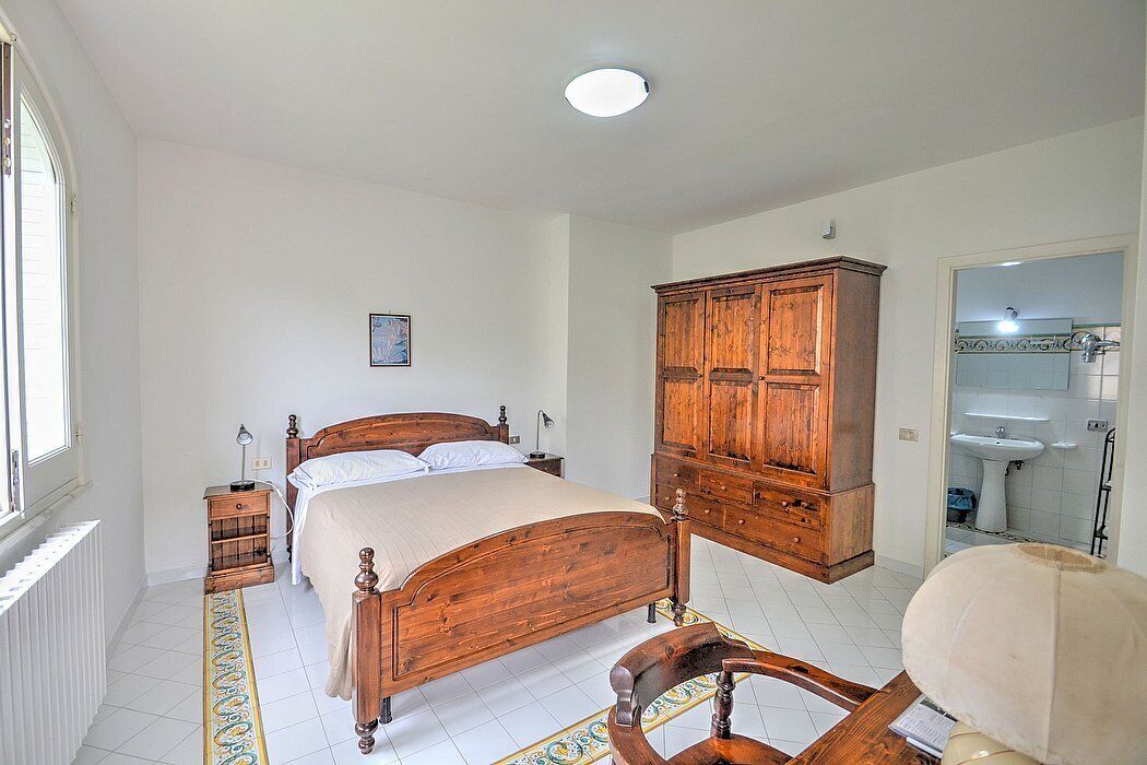 Appartamento Ulisse I: A characteristic two-story cottage located in an isolated position, on the slopes of a hill which is covered with olive groves.