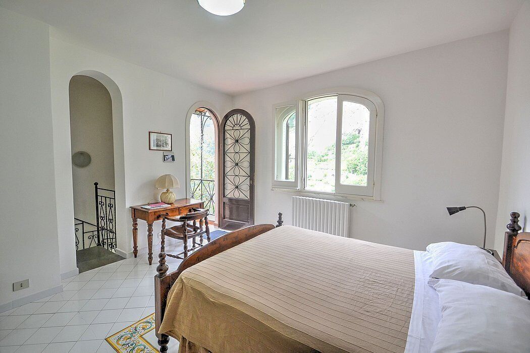 Appartamento Ulisse I: A characteristic two-story cottage located in an isolated position, on the slopes of a hill which is covered with olive groves.