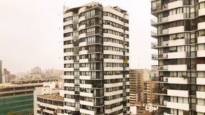 A high-rise building with multiple balconies, large windows, and a modern architectural design. - Exclusive, One Step Away from San Isidro (1302) (Lima)