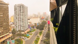 A cityscape with high-rise buildings, a road with vehicles, and a pedestrian crossing. - Exclusive, One Step Away from San Isidro (1302) (Lima)