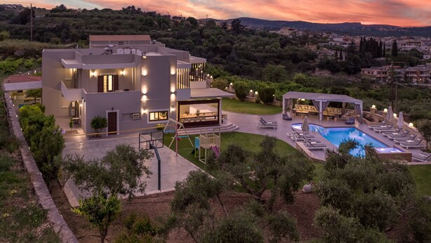 A modern two-story house with a swimming pool, outdoor seating, and a well-maintained garden. -  Elaida Villa, Refined Group Escape • Pool & Play (Rethymno)