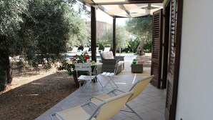 A covered patio with outdoor furniture, a pool, and a garden area. - IL VILLINO --- SWIMMING POOL NOT SHARED AND PRIVATE BEACH --- (Cefalù)