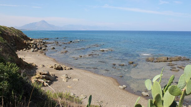 A coastal landscape with a rocky beach, clear blue water, and a mountain in the background. - IL VILLINO --- SWIMMING POOL NOT SHARED AND PRIVATE BEACH --- (Cefalù)
